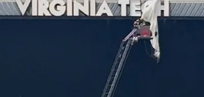 Fallschirmspringer kracht vor Footballspiel in Anzeigetafel